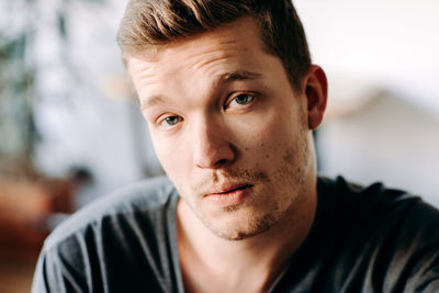 Portrait of young man at home