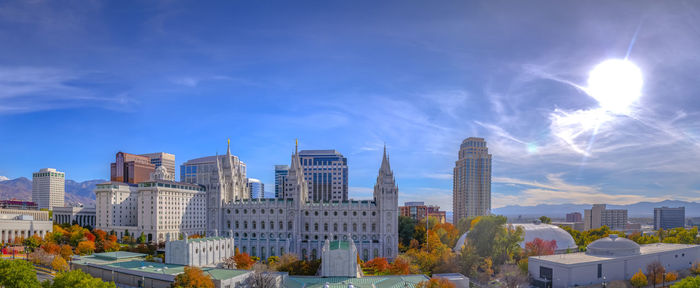 Modern buildings in city against blue sky