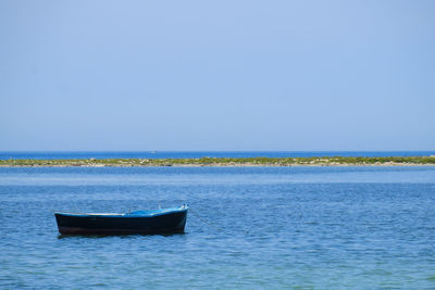 Boat in sea against clear sky