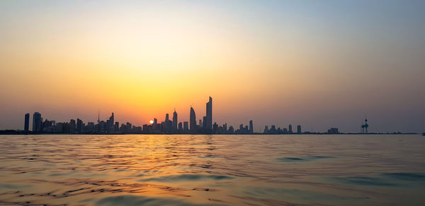 View of buildings in city during sunset