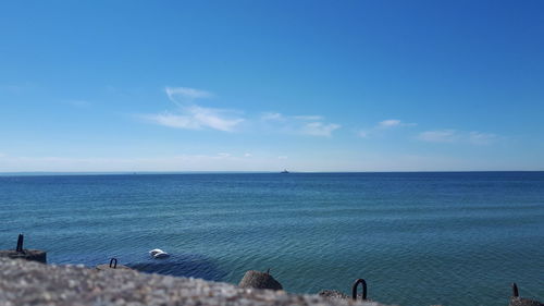 Scenic view of sea against blue sky