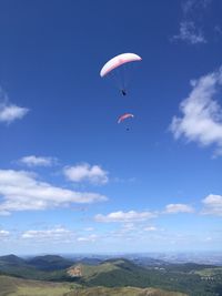 Low angle view of paragliding against sky