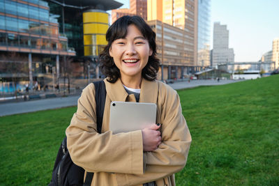 Portrait of young woman using mobile phone