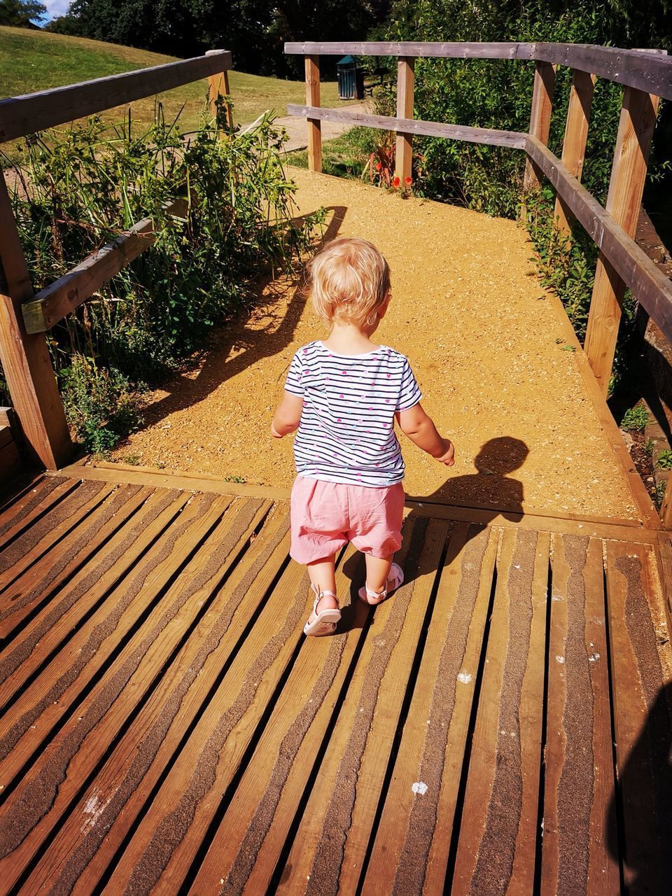 FULL LENGTH REAR VIEW OF BABY BOY ON WOOD