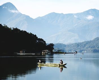 Scenic view of lake and mountains against sky