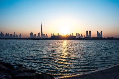 View of buildings in city during sunset