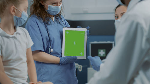 Midsection of doctor examining patient in hospital