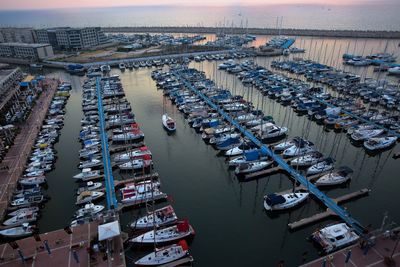 High angle view of boats moored on sea during sunset