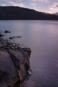 Scenic view of lake against sky at sunset