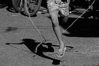 Low section of person standing on road