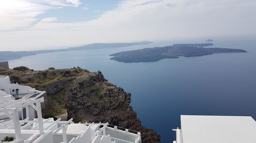 High angle view of buildings by sea against sky