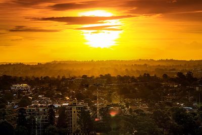 Aerial view of cityscape against sky during sunset