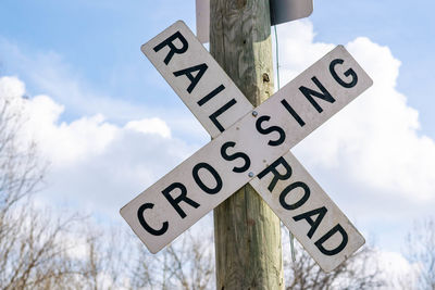 Low angle view of road sign against sky