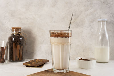 Delicious homemade cocoa drink with milk, cocoa powder and pieces of chocolate bar.