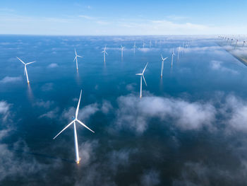 Low angle view of windmill against sky