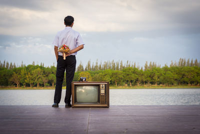 Rear view of man standing against sky