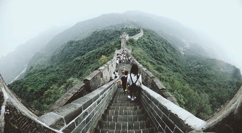 Rear view of people walking on mountain