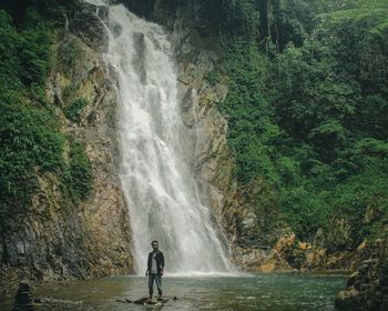 Scenic view of waterfall against trees