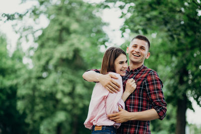 Smiling couple embracing at park