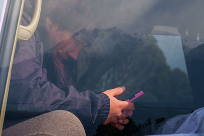 Multiple exposure midsection of person using mobile phone 