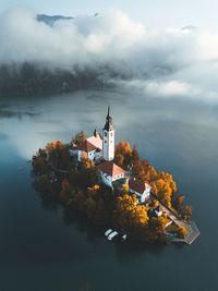 Traditional building by sea against sky