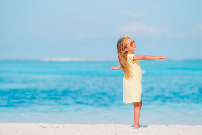 Man standing at beach against sky