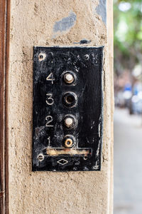 Close-up of old camera on wall