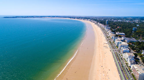 Aerial view of beach against blue sky