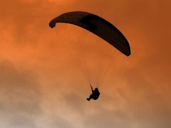 Low angle view of paraglider flying in sky