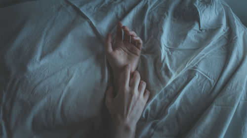 High angle view of woman relaxing on bed