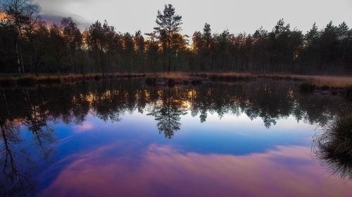 Scenic view of lake against sky at sunset