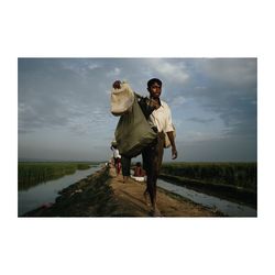 Men walking on landscape against sky