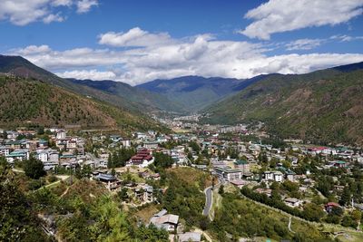 High angle view of townscape and mountains against sky