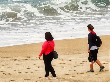 Rear view of man and woman on beach