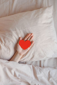 Close-up of heart shape on bed at home