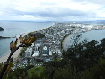 Aerial view of city against cloudy sky