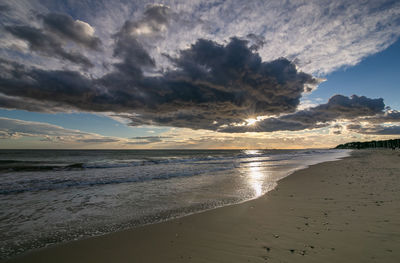 Scenic view of beach against sky during sunset