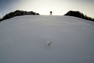 Man standing on snow covered land