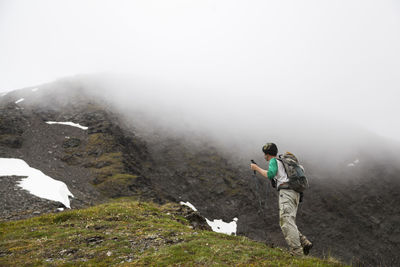 Man hikes ridge towards cooper mountain, kenai peninsula, alaska