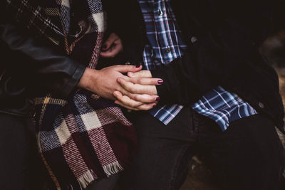 Midsection of man holding hands standing at home