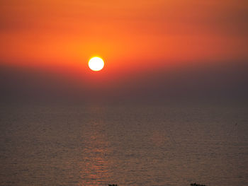 Scenic view of sea against romantic sky at sunset