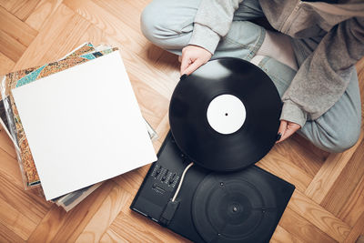 Woman playing music from vinyl record. analog record. retro and vintage style. analog sound. music