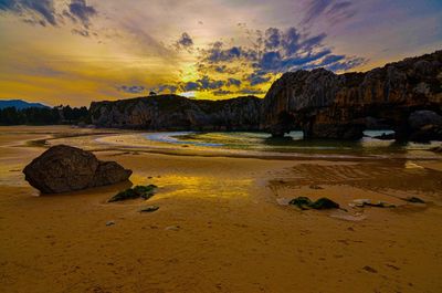 Scenic view of beach against sky during sunset