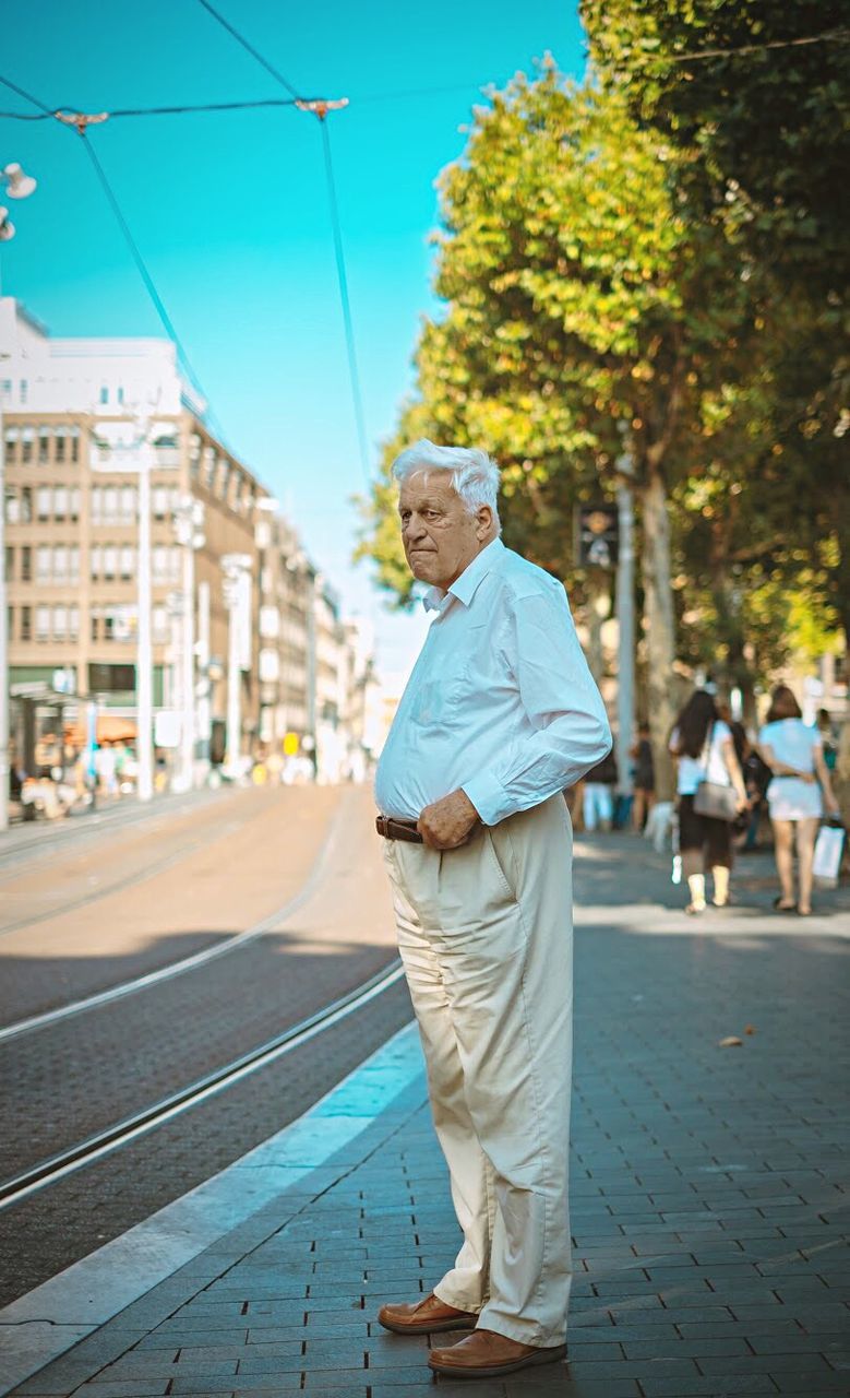 one person, full length, city, senior adult, real people, day, men, incidental people, footpath, adult, street, nature, architecture, walking, males, focus on foreground, lifestyles, built structure, building exterior, outdoors