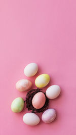 Directly above shot of easter eggs on pink background