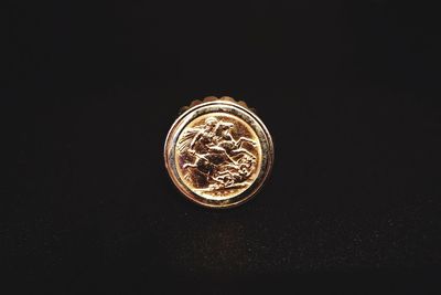 Directly above shot of coins on black background