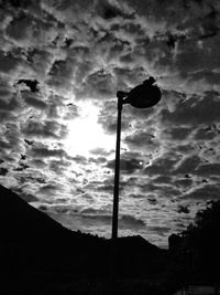 Low angle view of street light against cloudy sky