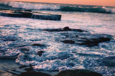Close-up of sea against sky during sunset