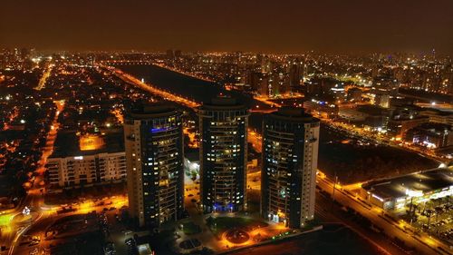 High angle view of illuminated buildings in city at night