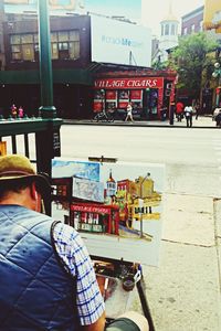 Man sitting in city
